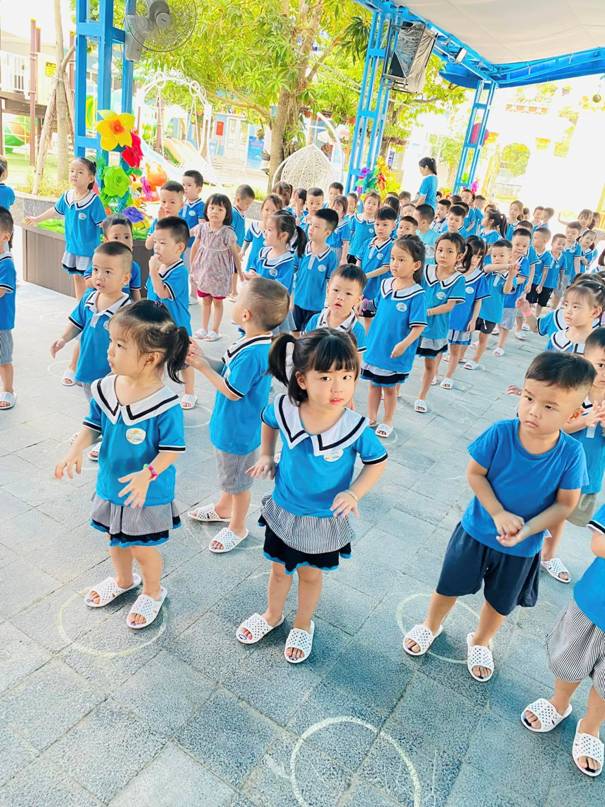 A group of children in blue shirts

Description automatically generated