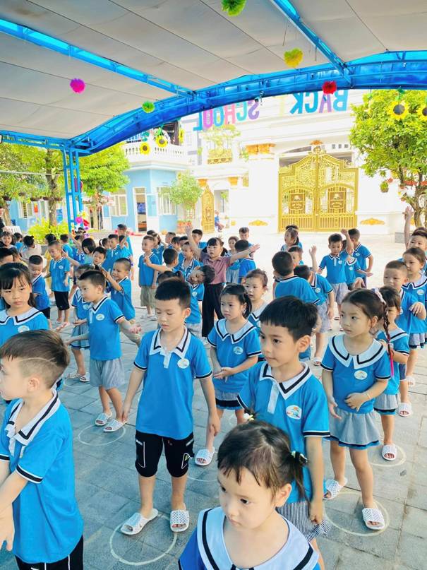A group of children in blue shirts

Description automatically generated